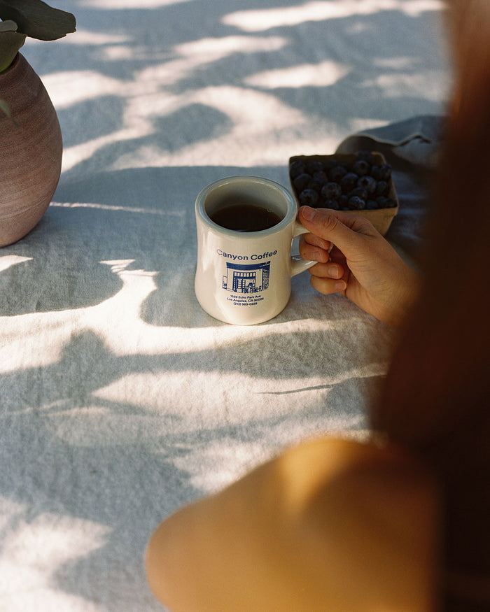 A diner mug with a drawing of Canyon Echo Park Cafe