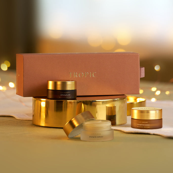 Tropic lip care gift set with Lip Smooth, Lip Fudge and Lip Dream beside terracotta gift box with fairy lights.