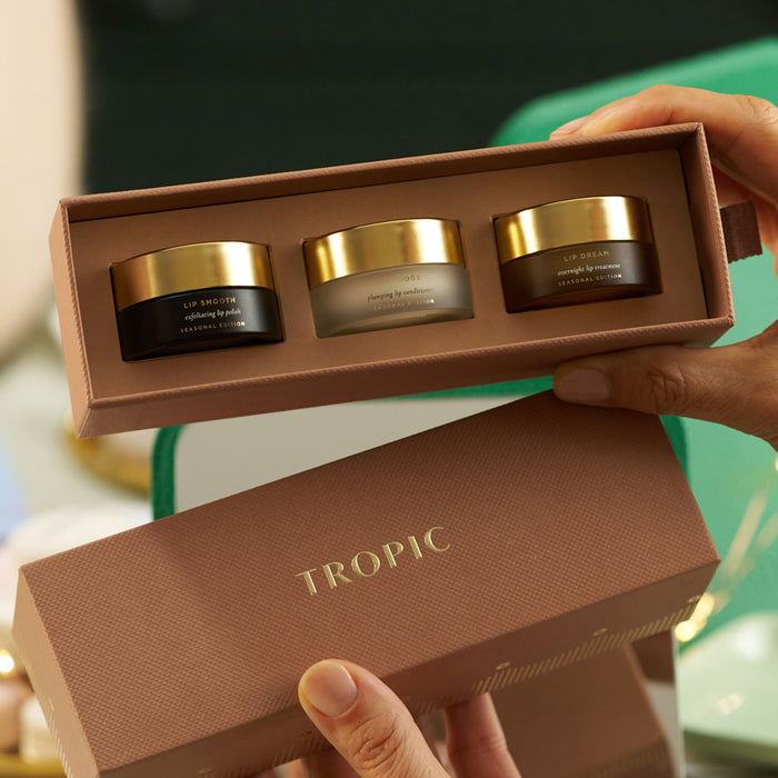 Tropic lip care gift set opened to reveal Lip Smooth, Lip Fudge and Lip Dream pots in a luxury brown box.