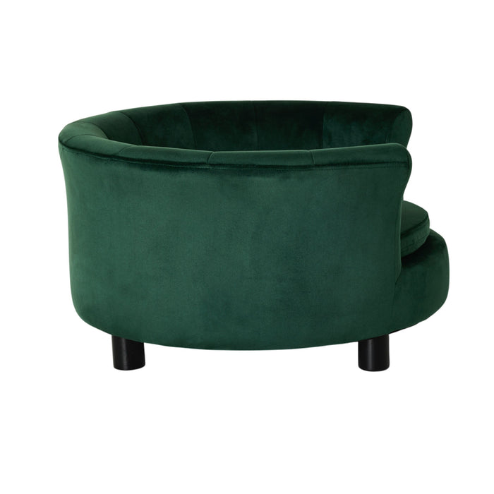 The Vivienne Velvet Pet Bed in Forest, measuring 65x65x36cm, is a round, green upholstered bed with plush padding and black cylindrical legs, shown elevated from the back on a white background.